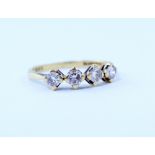 An 18ct gold ring set with four diamonds in claw settings, stamped 750, size N, approx 2.4g.