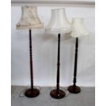 A 1930s oak standard lamp with turned column and two other standard lamps (3).