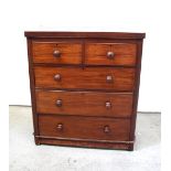 A Victorian mahogany chest of two short over three long drawers with turned handles on a plinth