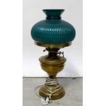 A brass oil lamp converted to electric, with green shade, height 48cm.