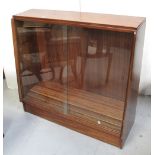 A mid-20th century floor standing bookcase with twin glazed doors, a nest of tables,