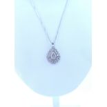 A 9ct white gold pear shaped pendant set with diamonds, on 9ct white gold chain,