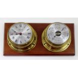 A Spectrum quartz porthole style clock and barometer set mounted on mahogany plinth, length 36cm.