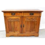 A red walnut sideboard comprising pair of drawers over carved cupboard doors with metalwork drop