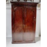 A large Victorian mahogany two-door wardrobe, the interior lower section with two drawers,