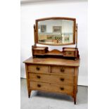 A c1910 British light oak bedroom suite comprising single-door wardrobe,