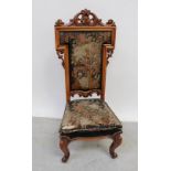 A 19th century carved walnut upholstered low chair with cabriole front legs.