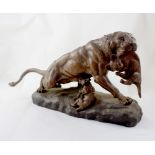 AFTER THOMAS CARTIER; a spelter figure group of a lioness with her cubs, signed, length 58cm.