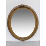 A 19th century oval gilt wood wall mirror with shell and floral frieze to top and bottom,