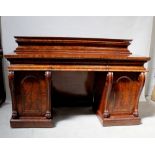 A Victorian flame mahogany twin-pedestal sideboard with shaped back above three cushion drawers and