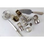 A group of mixed silver items including napkin rings, pepperette, pierced small basket,