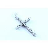 A white metal cross set with twenty one small diamonds.