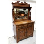 A late 19th century carved oak mirror-back sideboard with Art Nouveau motifs,