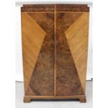 An Art Deco inlaid walnut four-piece bedroom suite comprising wardrobe, tallboy,