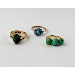 A 9ct gold dress ring set with a single green stone, approx 3.