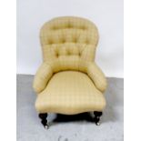 A 19th century mahogany upholstered button-back nursing chair with cream chequered pattern.