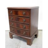 A reproduction bow-front chest of drawers of small proportions, on bracket feet, height 60cm.