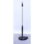 A mid-century standard lamp, the brass column on a stained wooden abstract shaped base,