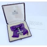 A cased MBE awarded to Dora Lund, early 20th century.