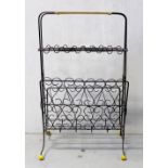 A modern wirework magazine rack on yellow plastic ball feet, height 62cm.