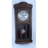 A 1920s oak-cased wall clock and an ornate turned mahogany torchère, height 110cm.