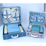 A Brexton picnic case with fitted interior containing four forget-me-not patterned plates,