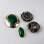 A silver brooch set with a large malachite stone, a similar smaller silver pendant,