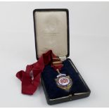 A 9ct gold enamelled shield-shaped medal,