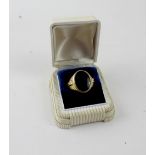 An American gentlemen's yellow metal signet ring set with onyx, stamped 10K, size V, approx 8.3g.