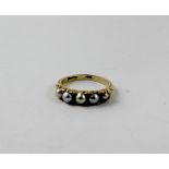 An 18ct gold dress ring set with five pearls, size G1/2, approx 2.2g.
