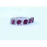 An 18ct white gold ring alternately set with five rubies and six pairs of diamonds (twelve in