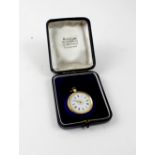 An 18ct yellow gold ladies' fob watch, the enamel and gilded dial set with Roman numerals,