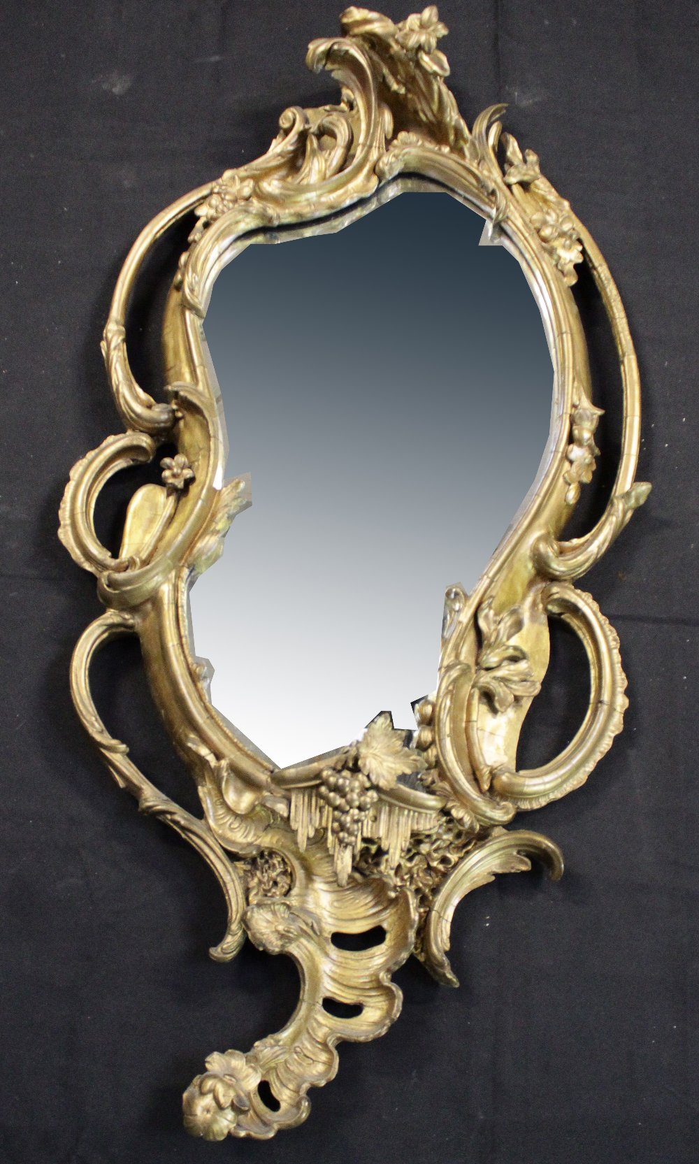 An early 20th century Rococo-style gilt wall mirror, height 145cm (af).