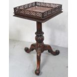 A reproduction mahogany galleried square top occasional table with turned bulbous column and three