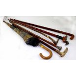 Six various walking sticks, canes and a vintage umbrella, to include horn and silver handles (6).