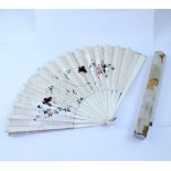 An early 20th century folding fan with bone guards and sticks,