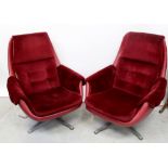 A pair of 20th century Scandinavian reclining armchairs upholstered in red velour and leatherette,