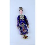 A Japanese wooden painted doll dressed in traditional attire, height 28cm.