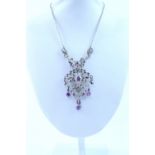 A silver openwork pendant, marked 925, set with marcasite and amethyst.
