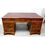 A George III style mahogany pedestal desk, the top with one long and two short drawers,