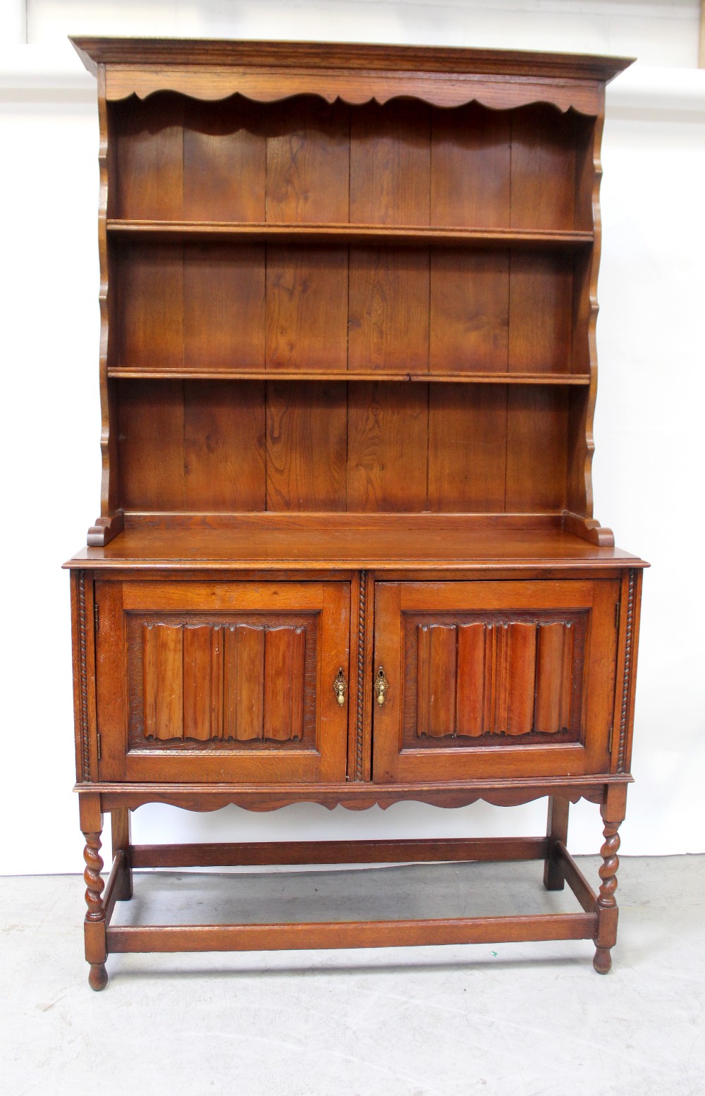 A reproduction stained oak dresser,