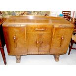 A 1930s oak break-front sideboard, three cupboards and one drawer on turned feet, width 138cm.