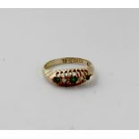 An 18ct gold dress ring set with three small green stones and two small diamonds, size H1/2,