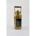 An early 20th century brass lantern with swing handle,