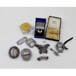 A quantity of costume jewellery to include cut steel buckles, brooches, gilt commemorative coin,