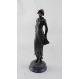 AFTER PREISS; a bronze figure of a 1920s lady wearing a hat and holding a handbag, on marble base,