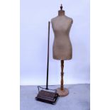 A vintage oak-framed tailors' dummy with canvas body and a vintage wood bodied Ewbank carpet
