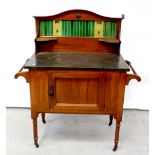 A Victorian mahogany wash stand with a green tile back and marble top,