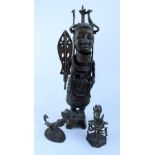 Benin bronze comprising large tribal figure in tribal outfit holding sword with hoop handle and two