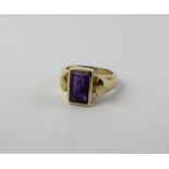 A 9ct gold dress ring set with baguette shaped purple stone, size G, approx 4.5g.